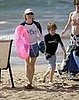Jodie Foster and her boys hit the beach in full sun protection mode.
